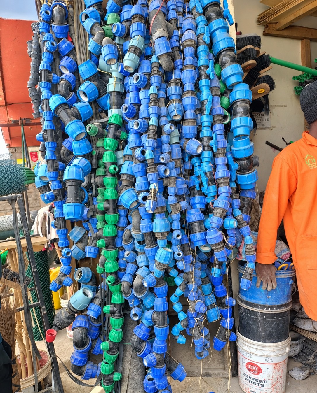 Wall of blue PVC pipe fittings and couplings at Gimjos hardware